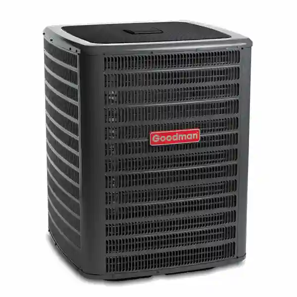 Goodman outdoor AC condenser unit isolated on a light gray background.